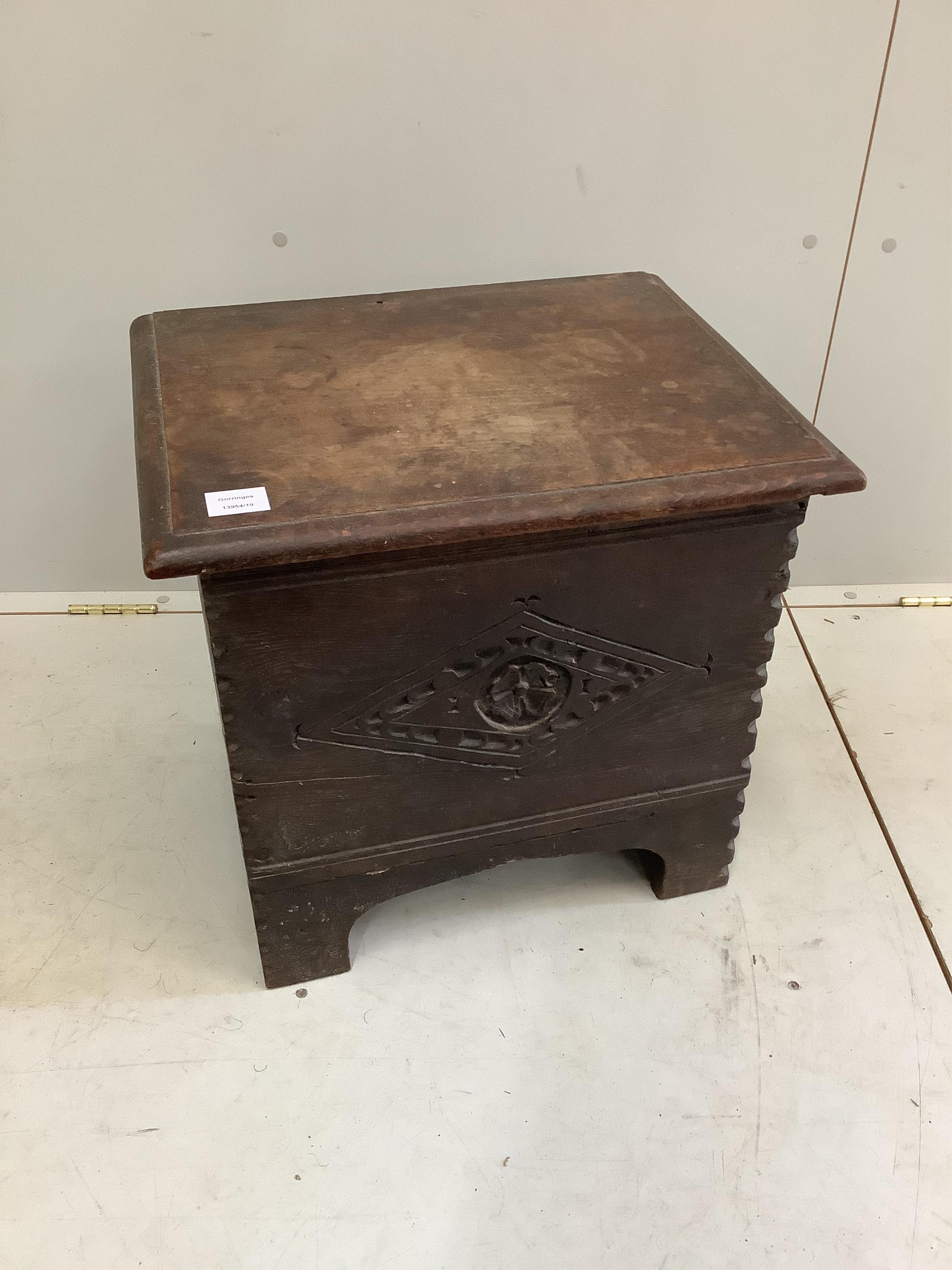 A small 17th century style carved oak coffer, width 51cm, depth 40cm, height 47cm